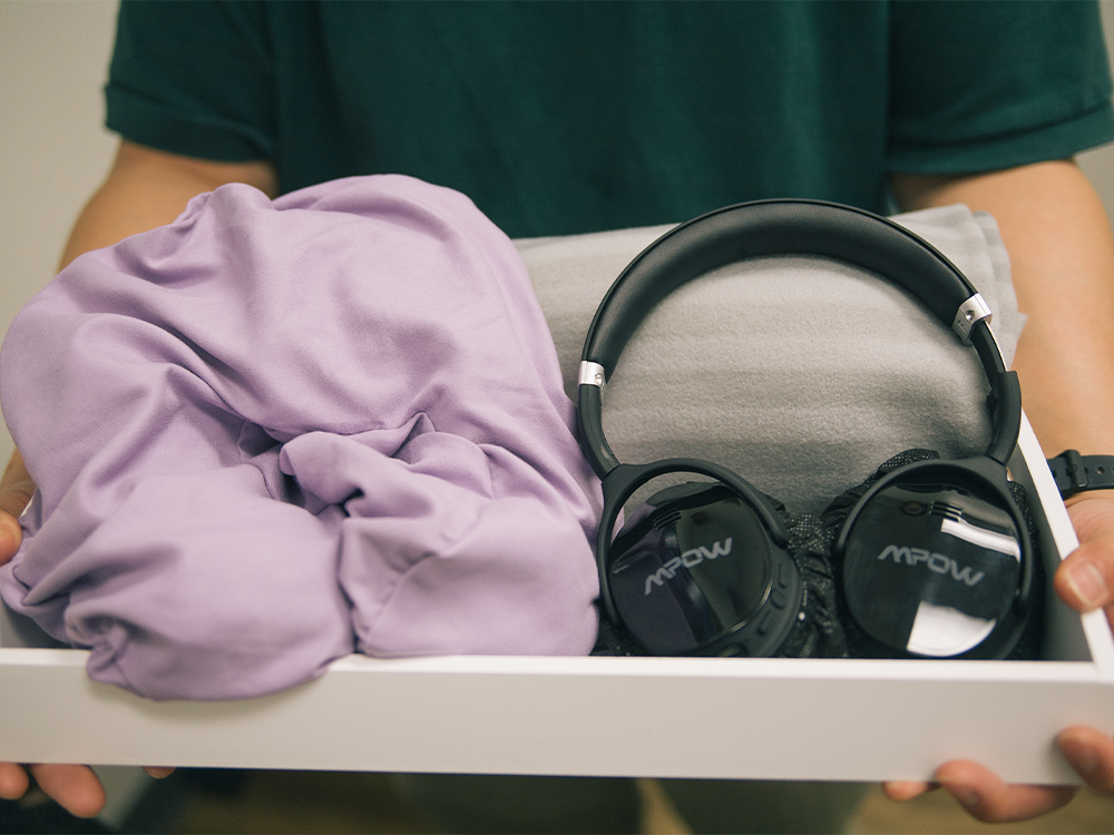 image of a pair of headphones and a blanket in a tray