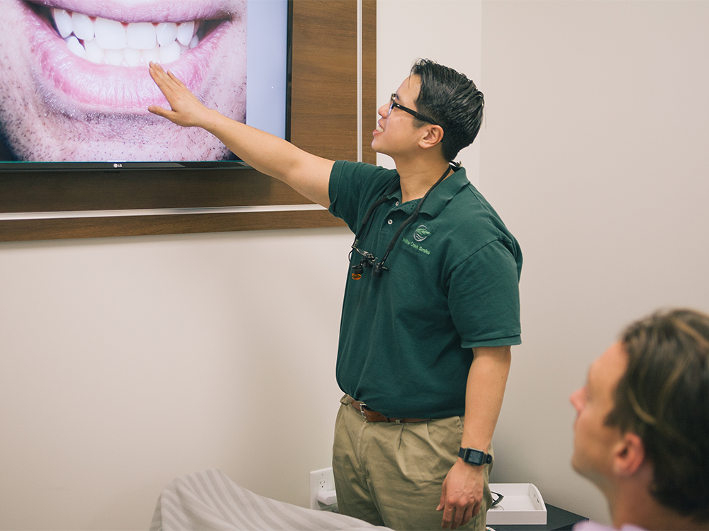 dr Nguyen pointing at a screen