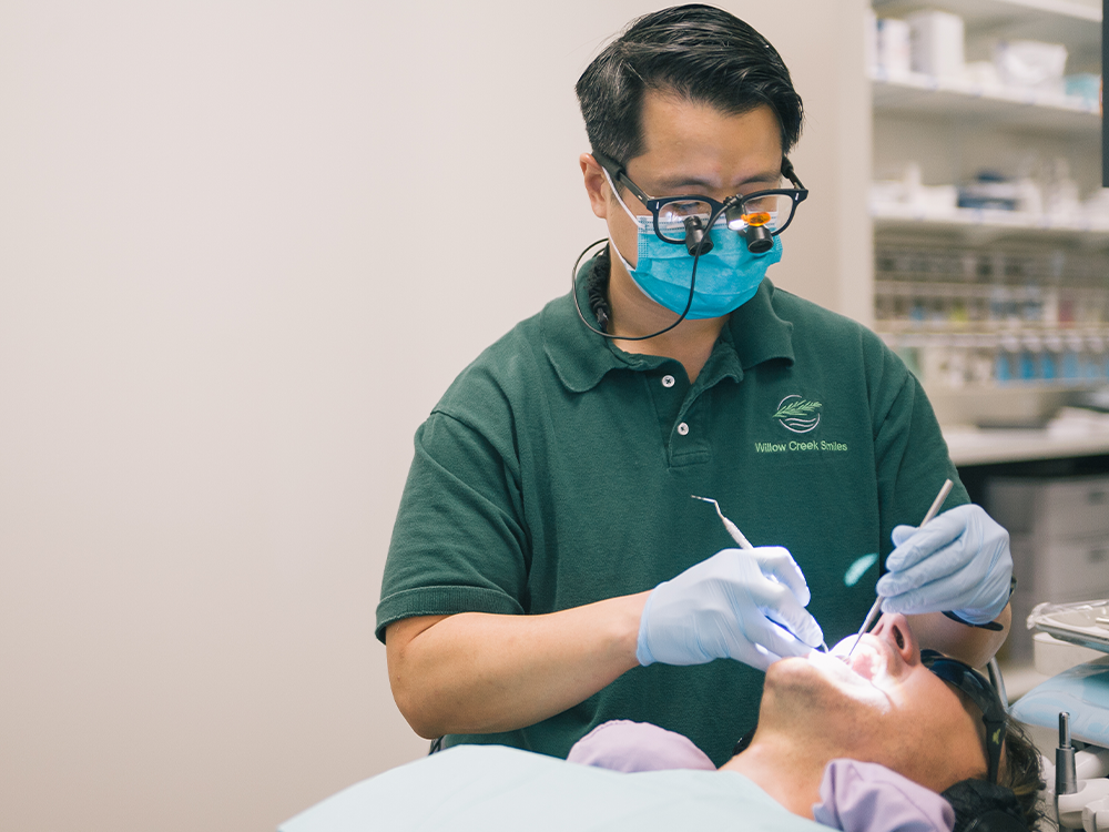 dr nguyen working on a patient teeth