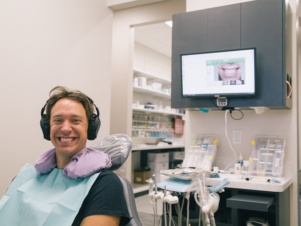 patient sitting in a chair in the dental office