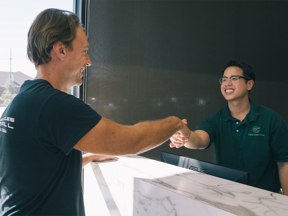 dr ngyuen greeting a patient at the front door